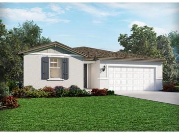 Charming single-story home with a manicured lawn, colorful flowerbeds, and attached two car garage at 1817 Draughton Dr, Zephyrhills, FL 33541