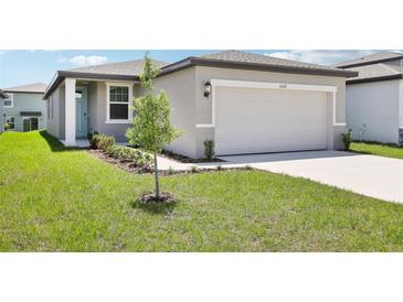 Charming one-story home with a well-manicured lawn and a two-car garage at 3539 Moscato Dr, Brooksville, FL 34602