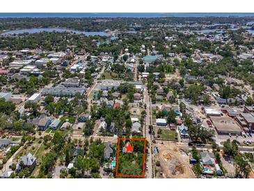 An aerial view shows the home's location amid the neighborhood with convenient access to nearby shops and roadways at 226 N Grosse Ave, Tarpon Springs, FL 34689