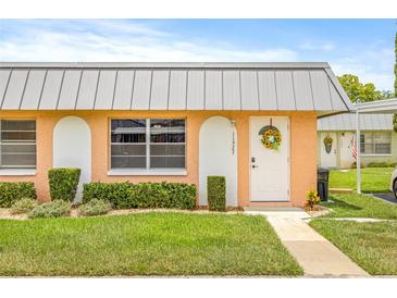 Charming single-story home with a well-manicured lawn, decorative accents, and inviting front door at 11923 Boynton Ln # B, New Port Richey, FL 34654
