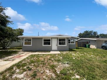 Charming home featuring a front yard with green grass and a neatly painted exterior with white trim at 4432 W Wallace Ave, Tampa, FL 33611