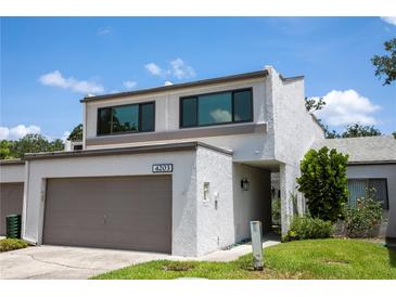 Charming two-story home with a large garage and well-maintained lawn and landscaping at 4203 Fairway Run, Tampa, FL 33618