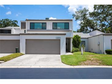 Stylish two-story home featuring a well-kept lawn, front yard landscaping, and an attached two-car garage at 4203 Fairway Run, Tampa, FL 33618