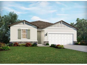 Charming one-story home showcasing stone accents, neutral siding, a two-car garage, and a beautifully landscaped front yard at 450 Sun Chaser Dr, Nokomis, FL 34275