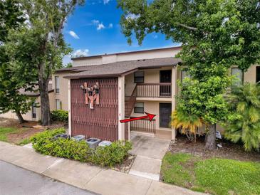 Inviting condo exterior with mature landscaping and a private entrance, unit 4 at 1200 Tarpon Woods Blvd # L4, Palm Harbor, FL 34685