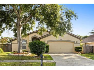 Charming one-story home with a well-maintained lawn, mature trees, and an attached two-car garage at 1716 Westerly Dr, Brandon, FL 33511