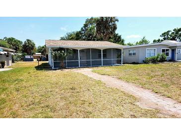 Charming single story home featuring a screened-in porch and welcoming brick walkway at 530 74Th N Ave, St Petersburg, FL 33702