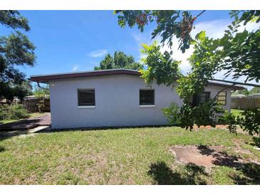 Exterior view of backyard featuring grass and the rear of the house at 8035 Robin Rd, Seminole, FL 33777