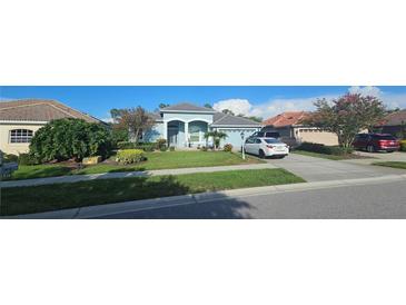 Charming one-story home featuring a well-manicured lawn, inviting curb appeal, and a two-car garage at 1884 Coconut Palm Cir, North Port, FL 34288
