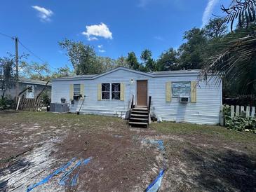 Cozy single-story home with white siding and a small front porch, surrounded by a partially landscaped yard at 12141 Terra Ceia Ave, New Port Richey, FL 34654
