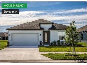 Charming single-story home with a well-maintained lawn and a two-car garage at 11126 Jenny Wren Rd, Weeki Wachee, FL 34614
