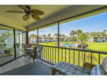Screened patio overlooking green space and community pool at 3805 E Bay Dr # 204, Holmes Beach, FL 34217