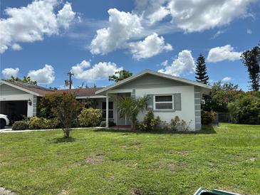 Charming single-story home with a well-maintained lawn and vibrant landscaping at 4650 Orlando Cir, Bradenton, FL 34207