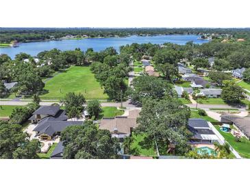 Expansive aerial view of a neighborhood with lush greenery and a large lake in the background at 2531 Lake Ellen Dr, Tampa, FL 33618