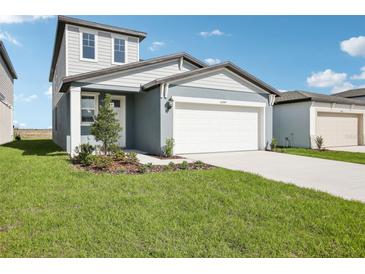 Charming two-story home with a well-maintained lawn, two car garage and meticulous landscaping at 3544 Moscato Dr, Brooksville, FL 34602