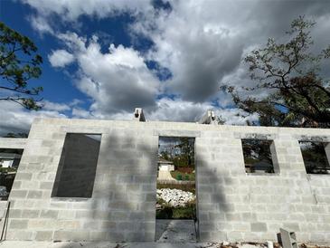 Image of a new block foundation with window and door openings under a cloudy, blue sky at 18141 Spartonvail Ave, Port Charlotte, FL 33954