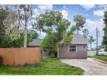 Quaint single-story home featuring a new roof, neutral paint, and a well-maintained front yard with mature landscaping at 4358 Murdock Ave, Sarasota, FL 34231