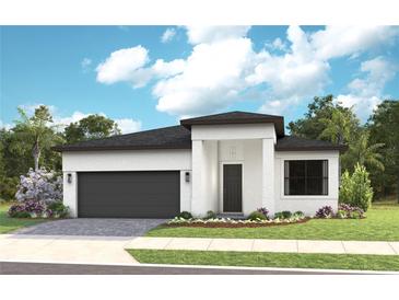 Modern home showcasing a clean white facade, dark roof, complemented by a well-manicured lawn and landscaping at 14375 Hammock Oak St, Parrish, FL 34219