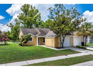 Charming single-story home with a well-maintained lawn and mature trees in a tranquil, inviting neighborhood at 7728 Balharbour Dr, New Port Richey, FL 34653