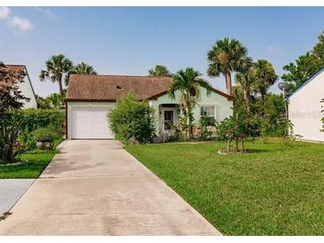 Charming single-story home with well-manicured lawn, mature landscaping, and a convenient attached garage at 1244 E Corktree Cir, Port Charlotte, FL 33952