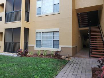 Inviting exterior view with landscaped front and staircase access in a well-maintained building at 4307 Bayside Village Dr # 103, Tampa, FL 33615