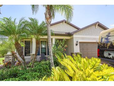 Charming home exterior with lush tropical landscaping and a welcoming front entrance at 2647 Running Oak Ct, North Port, FL 34289