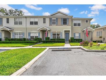 Charming townhouse with blue shutters and well-manicured landscaping at 5857 Fishhawk Ridge Dr, Lithia, FL 33547
