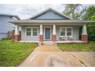 Charming bungalow with a cozy front porch and tidy landscaping; ideal for relaxing outdoors at 3610 N Tampa St, Tampa, FL 33603