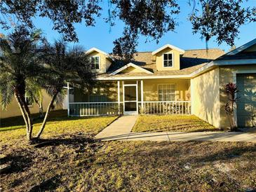 House exterior featuring a screened porch, walkway, and well-maintained lawn at 4147 Kingsfield Dr, Parrish, FL 34219