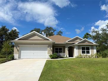 New construction home with attached garage and landscaped lawn at 3481 Nashville Rd, North Port, FL 34288