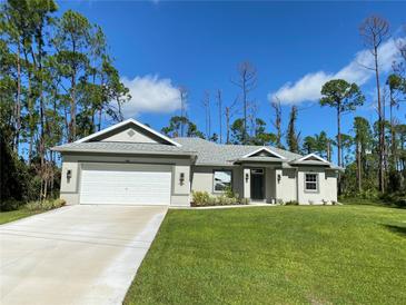One-story home with gray exterior, white garage door, and a well-manicured lawn at 1828 Spaniel Ave, North Port, FL 34288
