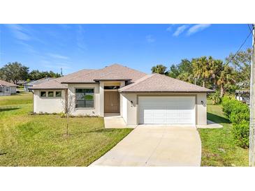 Single-story home with attached garage and landscaped lawn at 49 Marajo St, Punta Gorda, FL 33983