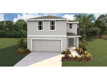 Two-story home with gray siding, attached garage, and landscaped yard at 30942 Wild Juniper Ct, Brooksville, FL 34602