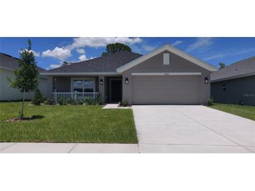Charming single-story home with a well-maintained lawn and a two-car garage at 13221 Gulf Bay Ln, Spring Hill, FL 34609