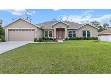 Charming single Gathering home featuring a spacious lawn, attached two car garage and meticulous landscaping at 4196 Hoffman Ave, Spring Hill, FL 34606
