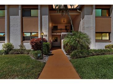 Inviting condo exterior with manicured landscaping and a walkway to the entrance at 2756 Clubhouse Dr # 101, Sarasota, FL 34232