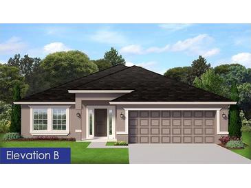 Charming single-story home featuring neutral paint, a dark roof, an attached two-car garage, and manicured landscaping at 4841 Sutherland St # Lot 58, Spring Hill, FL 34609