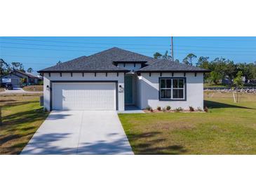 Charming single-Gathering home featuring a two-car garage and a well-maintained lawn at 2223 Hattie Ct, North Port, FL 34288