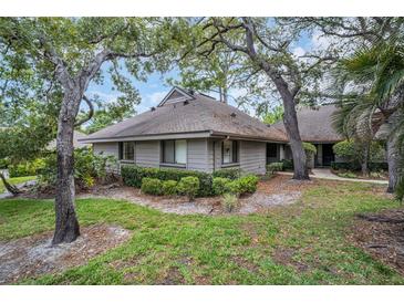 Charming single-story home nestled amongst mature trees with well-maintained landscaping at 1001 Old Mill Pond Rd, Palm Harbor, FL 34683