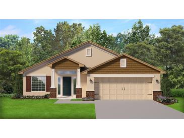 Charming single-story home featuring a symmetrical facade, a two-car garage and manicured front lawn at 4904 Sutherland St # Lot 66, Spring Hill, FL 34609