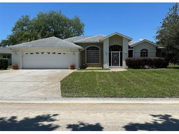 Charming single-story home with a two-car garage, well-manicured lawn, and inviting curb appeal at 9685 Southern Belle Dr, Weeki Wachee, FL 34613
