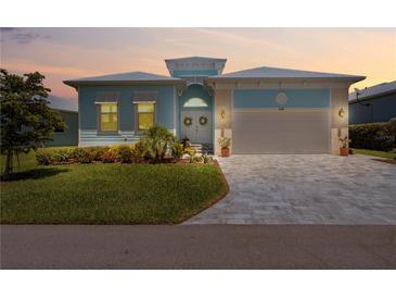 Charming single-Gathering home with a well-manicured lawn and a two-car garage at sunset at 10391 Coquina Ct, Placida, FL 33946
