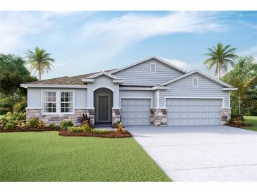 Charming single-Gathering home with a three-car garage, stone accents, and a well-manicured lawn at 11296 Curio Dr, Brooksville, FL 34613