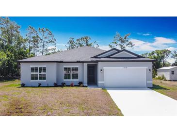 Charming single-story home with a well-maintained lawn and a two-car garage at 3018 Oceanside St, North Port, FL 34286
