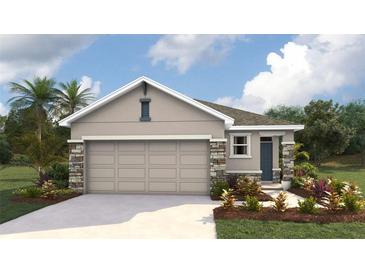 Charming single-story home featuring a neutral color palette, stone accents, and a two-car garage, set in a landscaped yard at 10452 Tucker Rd, Weeki Wachee, FL 34613