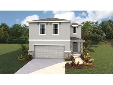 Charming two-story home with landscaped yard and attached two-car garage, perfect for a growing Gathering at 10492 Tucker Rd, Weeki Wachee, FL 34613