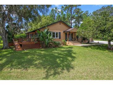 Charming bungalow with a lush lawn and inviting deck, perfect for relaxing outdoors at 39 Sunset Dr, Brooksville, FL 34601