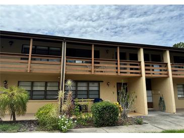 Charming two-story condo with a private balcony overlooking the landscaped front yard at 24 Quails Run Blvd # 3, Englewood, FL 34223