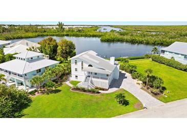 Waterfront property with lush landscaping and canal view at 13065 Via Aurelia, Placida, FL 33946