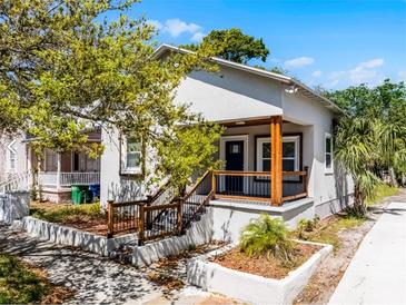 Charming stucco home with a cozy front porch and well-maintained landscaping at 2335 W Beach St, Tampa, FL 33607